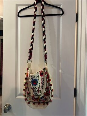Embroidered Cream Crossbody Bag with Multicolor Floral Accents and Pom poms